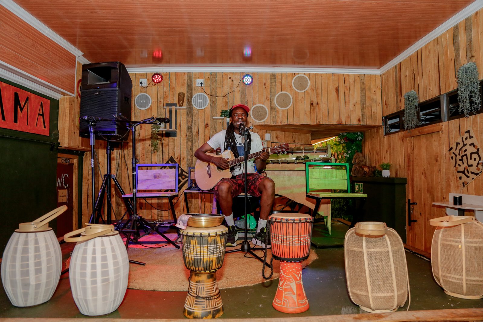 Colourful hand-painted tables and African art inside the Mama Africa dining room