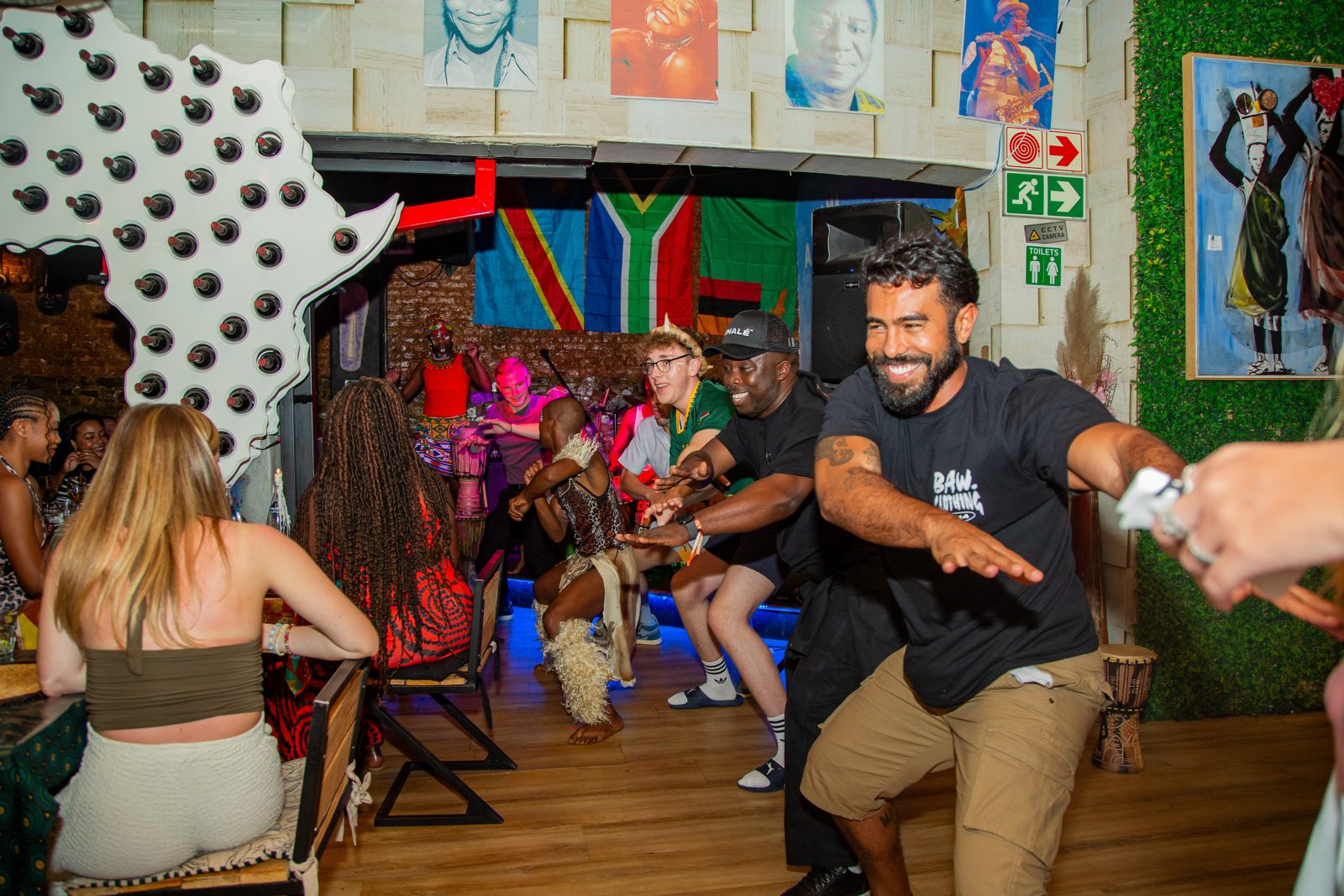 Guests dancing with performers in the dining room